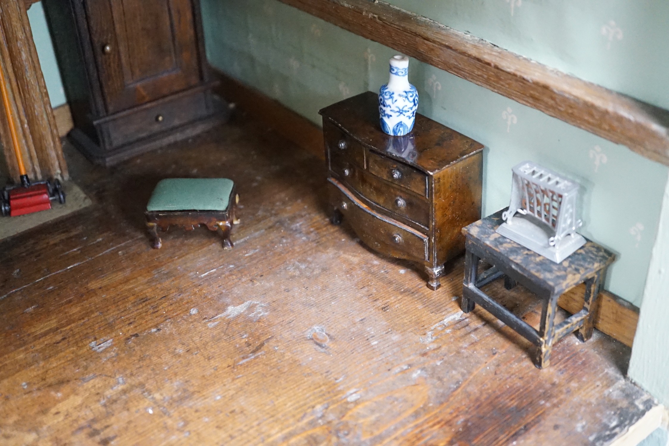 An early 19th century painted doll's house with block work facade enclosing a four room interior with central staircase, to be sold with assorted later furniture and accessories, width 117cm, depth 48cm, height with asso